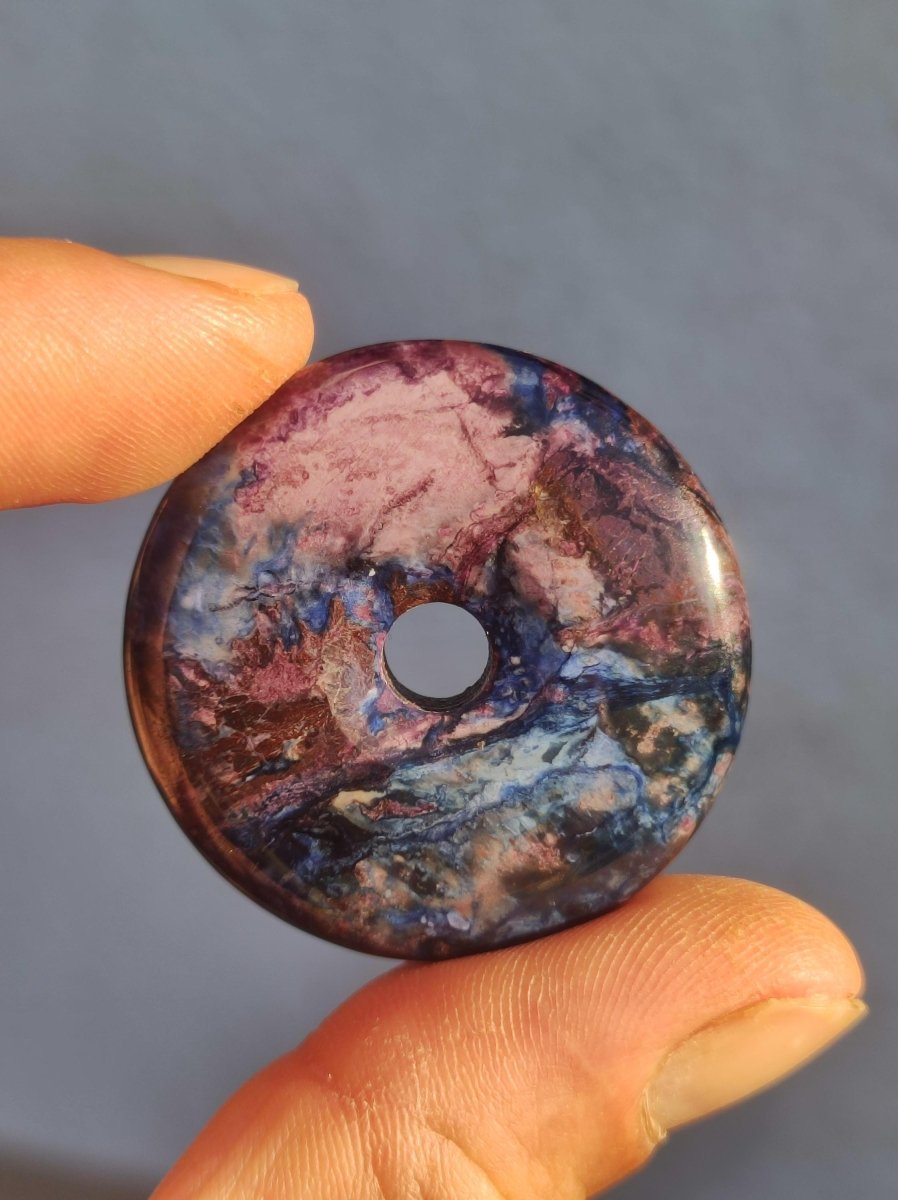 Sugilith & Richterit Bustamit Schutz Donut Edelstein Kristall Heilstein Rarität Selten Sammler Sugilit rot blau lila Anhänger rund Geschenk - Art of Nature Berlin